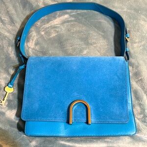 Fossil handbag in great blue color at blue color. It’s suede and leather.
